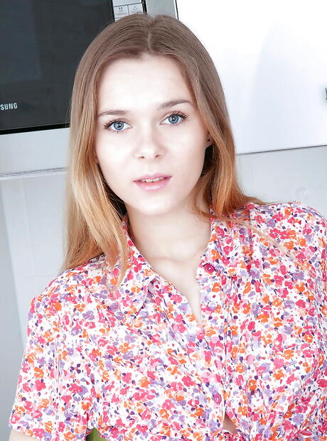 Gracile youthful Karissa in fancy shorts denudes small tits and spreads her legs in the kitchen